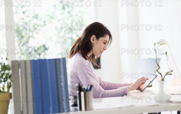 Young woman using digital tablet.