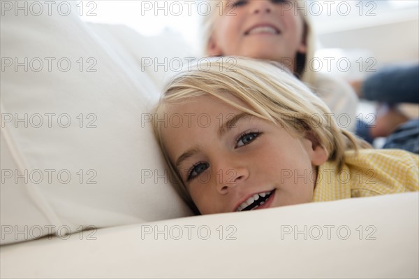 Boy (4-5) and girl (6-7) looking at camera