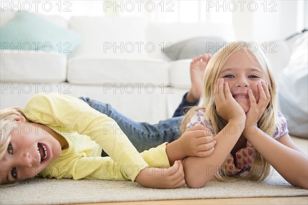 Boy (4-5) and girl (6-7) lying on floor