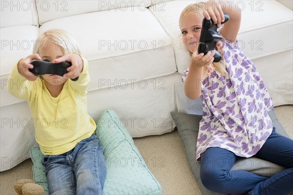 Boy (4-5) and girl (6-7) playing video game