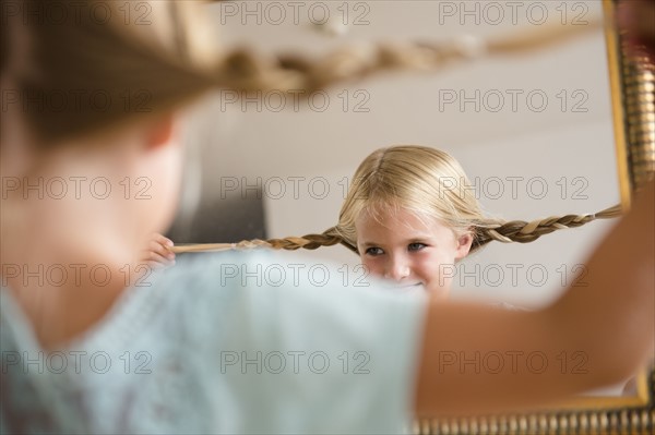 Girl (6-7) reflecting in mirror