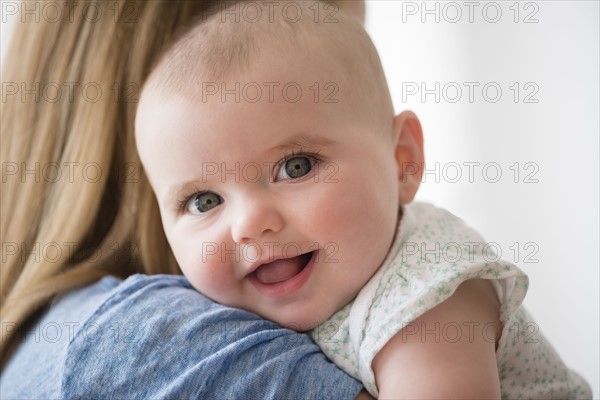 Portrait of baby girl (12-17 months) with mother