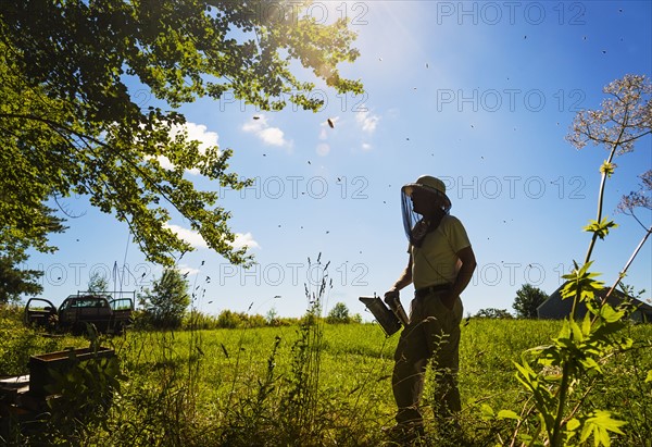 Hope, Beekeeper standing with smoker