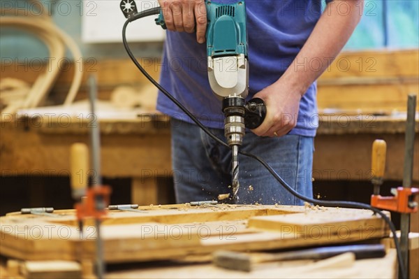 Carpenter using drill