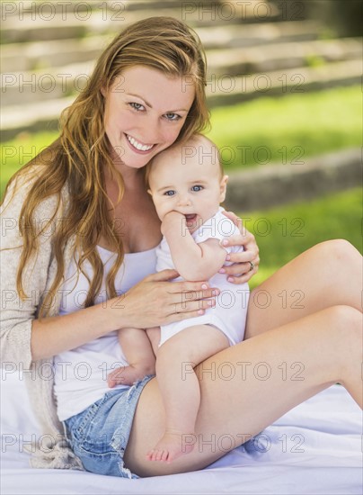 Mother holding baby (6-11 months) on lap