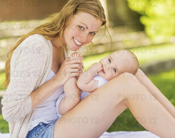 Mother holding baby (6-11 months) on lap