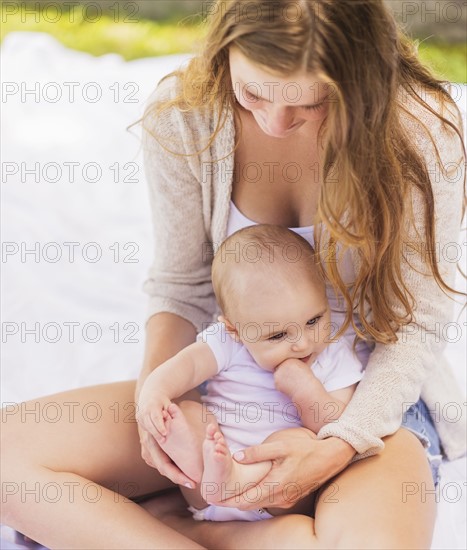 Mother sitting with baby boy (6-11 months)