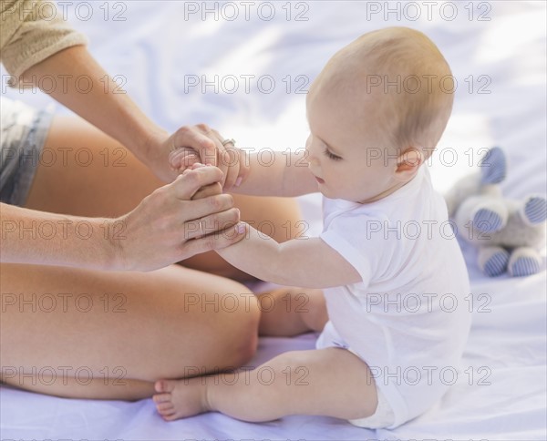 Mother sitting with baby boy (6-11 months)