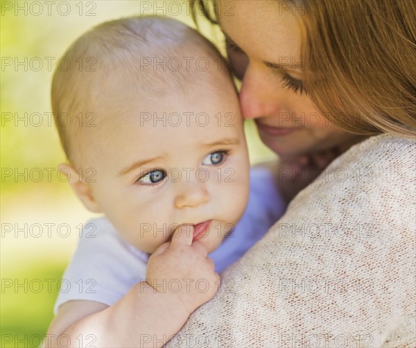 Mother holding baby boy (6-11 months)