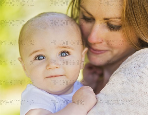 Mother holding baby boy (6-11 months)