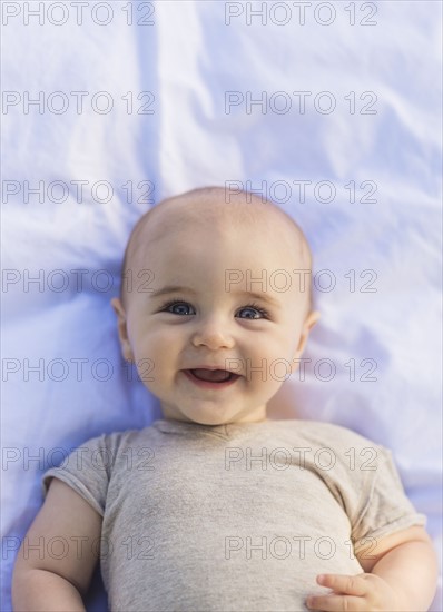 Portrait of baby boy (6-11 months) lying down