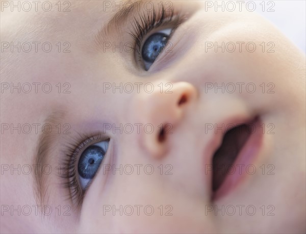 Close-of baby boy's (6-11 months) smiling face