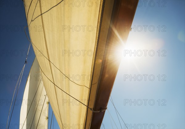 Close-up of sun shining through boat's sail