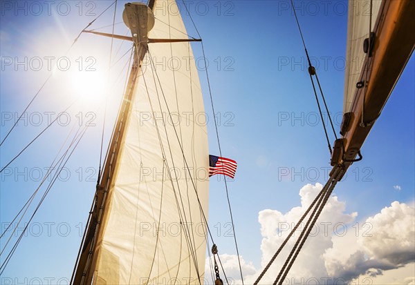 Close-up of sun shining through boat's sail