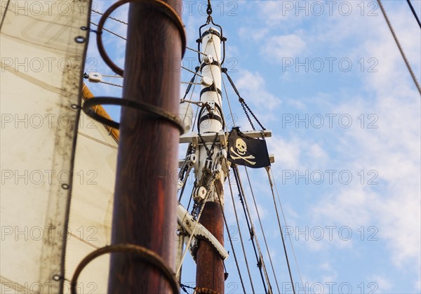 Close-up of sailboat's mast and pirate flag