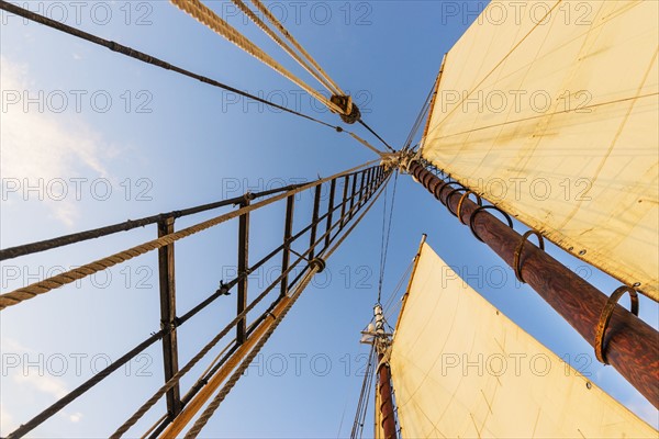Sail and mast against clear sky