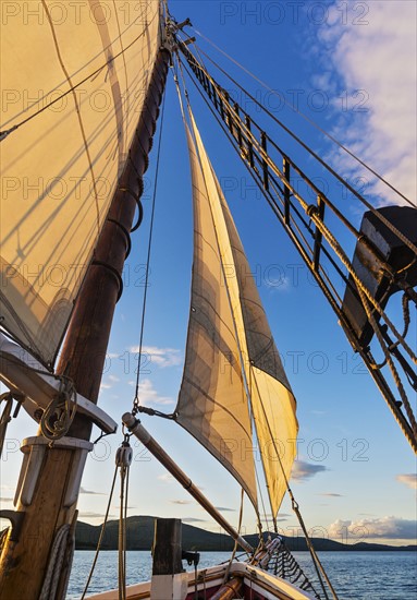 Sail and ropes against sunset sky