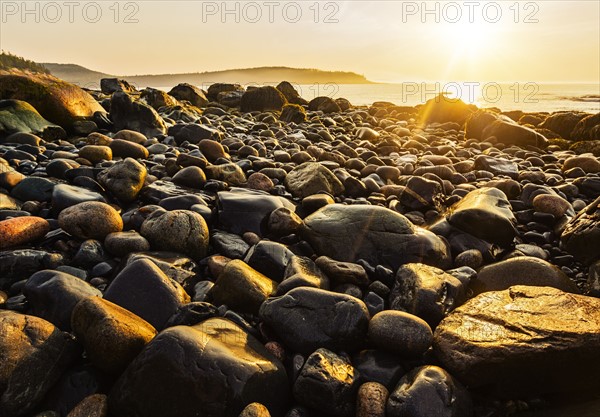 Rocks on beach at sunrise