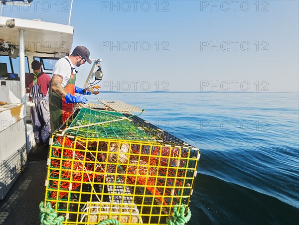 Two fishermen working on boat