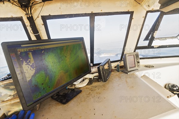 Directions on device screen inside fishing boat