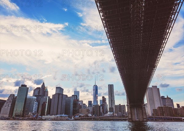 Brooklyn Bridge over Hudson River with financial district in background
