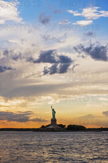 Silhouette of Statue of Liberty at sunset