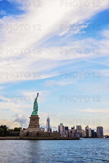 Statue of Liberty and financial district at dusk