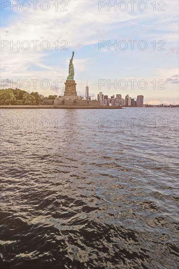 Statue of Liberty and financial district at dusk