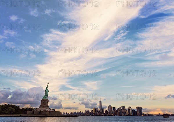 Statue of Liberty and financial district at dusk