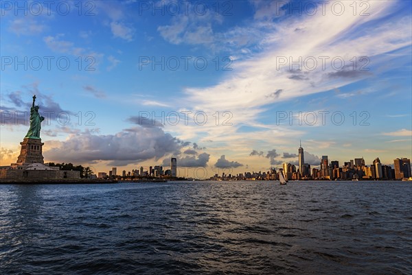 Statue of Liberty and financial district at dusk