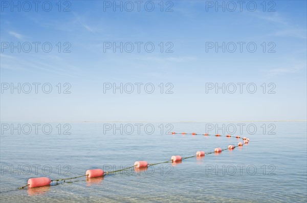 Rope with buoys on calm sea