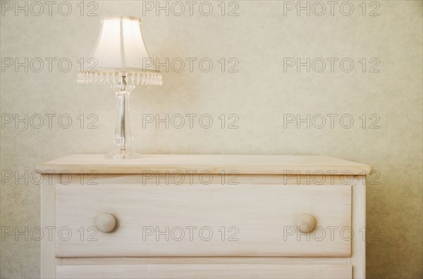 Electric lamp on wooden dresser