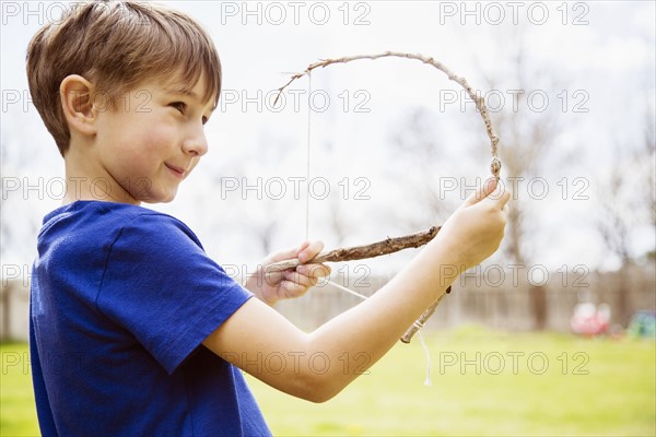 Portrait of boy (6-7) with toy bow