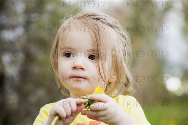 Portrait of girl (2-3) holding flower