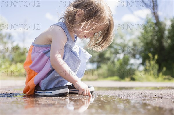 Portrait of girl (2-3) playing in puddle