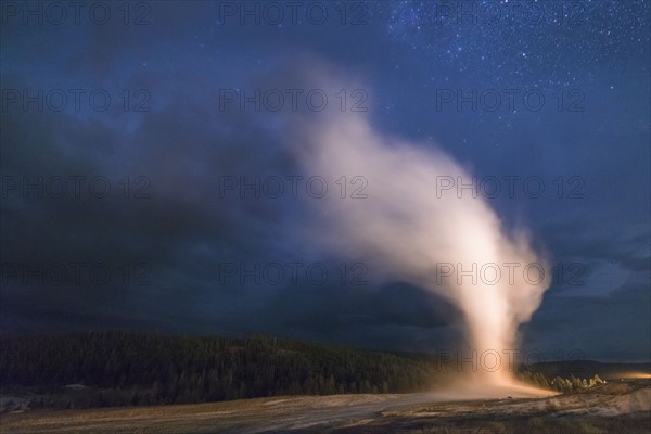 Geyser erupting at night