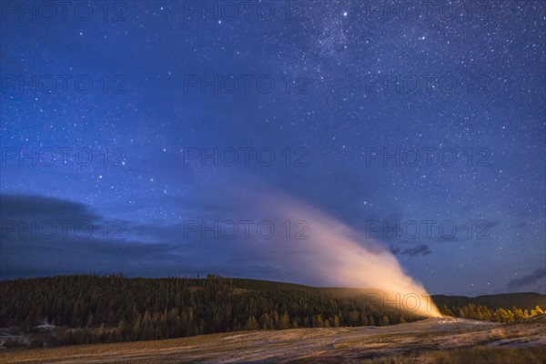 Geyser erupting at night