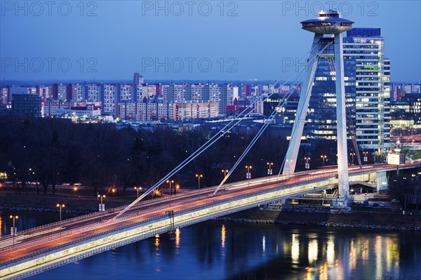 Illuminated bridge over river