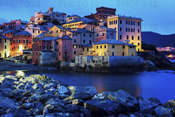 Boccadasse harbor with city at sunrise