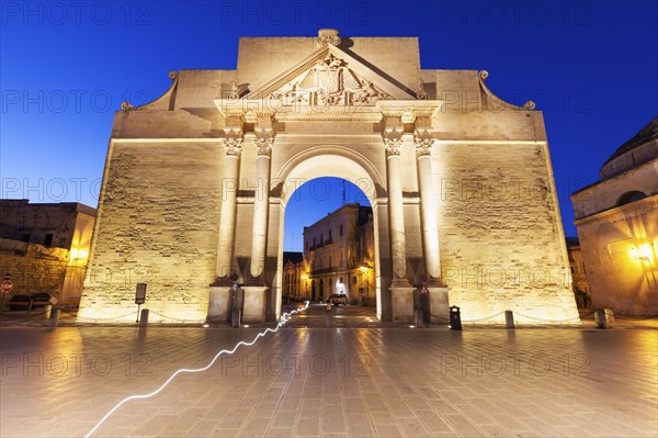 Porta Napoli illuminated at dusk