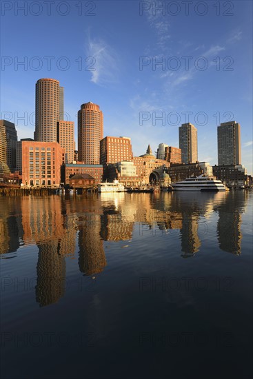 City waterfront reflected in harbor