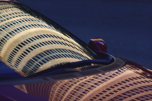 Reflection of buildings in car hood