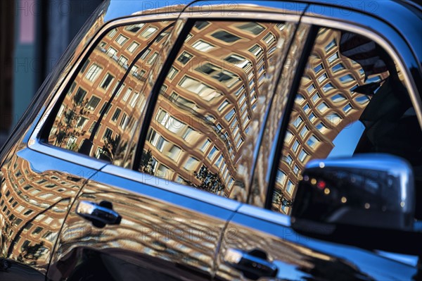 Building reflected in car