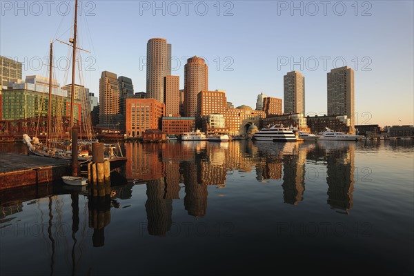 City waterfront reflected in harbor