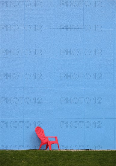 Red chair by blue wall