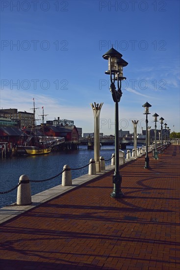 Pedestrian walkway at waterfront in sunlight