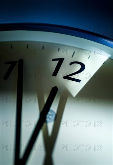 Close-up of clock on blue background.