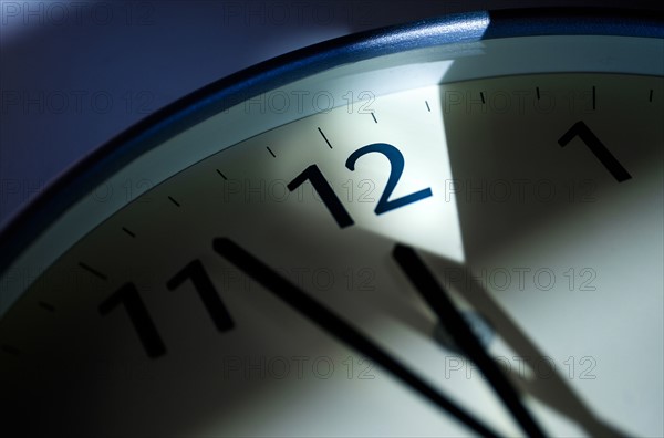 Close-up of clock on blue background.