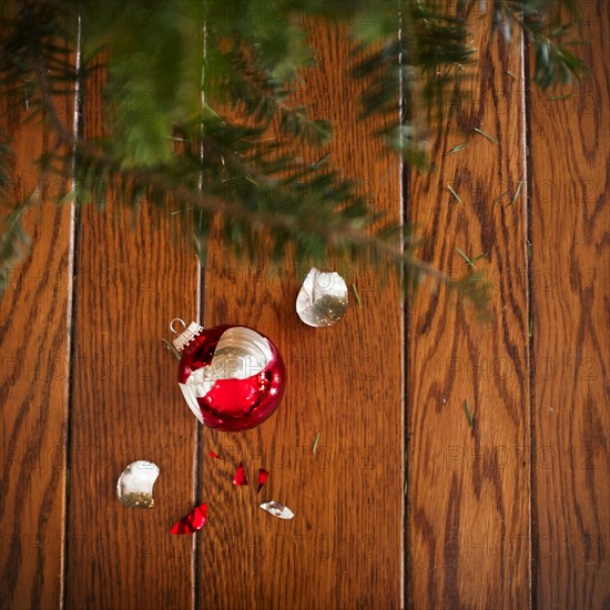 Broken christmas ornament on floor.