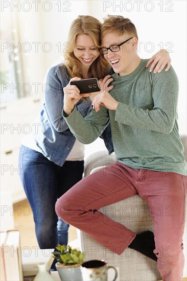 Young couple watching movie on smart phone.